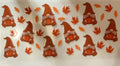 Fall tumbler wrap with orange gnomes holding pumpkins and autumn leaves